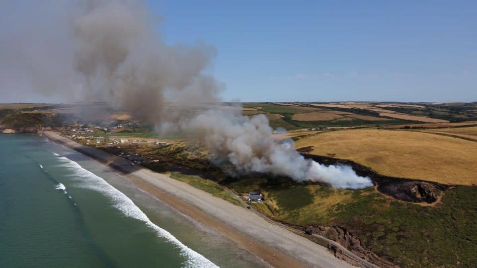 Drone photos show a large fire above blue flag beach in Pembrokeshire (Rou Chater / SWNS)