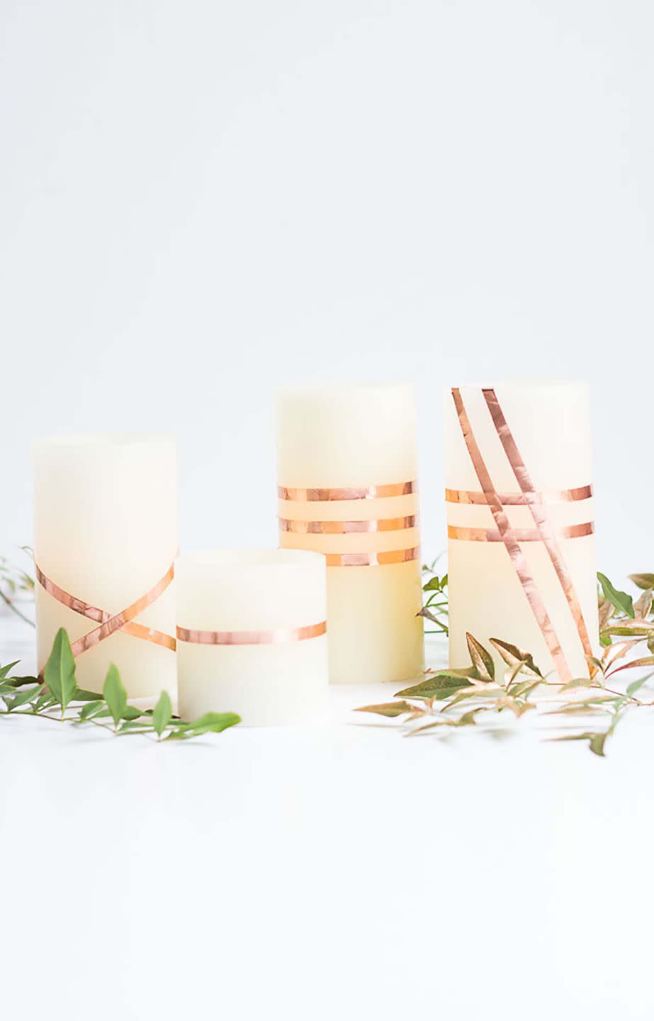 <p>Add some flair to the flameless candles you already have by creating patterns with some <a rel="nofollow noopener" href="https://www.amazon.com/Copper-Conductive-Adhesive-4inch-36yards/dp/B01CH4LYZ6" target="_blank" data-ylk="slk:copper foil tape;elm:context_link;itc:0;sec:content-canvas" class="link ">copper foil tape</a>. </p><p><strong>Get the tutorial at <a rel="nofollow noopener" href="http://www.designimprovised.com/2016/10/diy-copper-wrapped-candles.html" target="_blank" data-ylk="slk:Design Improvised;elm:context_link;itc:0;sec:content-canvas" class="link ">Design Improvised</a>.</strong> </p>