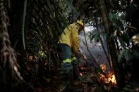 Brazilian Institute for the Environment and Renewable Natural Resources (IBAMA) fire brigade members attempt to control hot points in a tract of the Amazon jungle near Apui