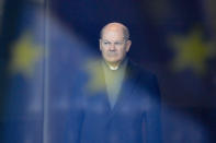 FILE - German Chancellor Olaf Scholz stands behind a reflection of the European flag in a window, as he waits for the arrival of Iraq's Prime Minister Mohamed Shia al-Sudani at the chancellery in Berlin, Germany, Jan. 13, 2023. German politics are in a disgruntled, volatile state as the country's voters prepare to fill 96 of the 720 seats at the European Parliament on June 9, the biggest single national contingent in the 27-nation European Union. It's the first nationwide vote since center-left Chancellor Olaf Scholz took power in late 2021. (AP Photo/Markus Schreiber, File)