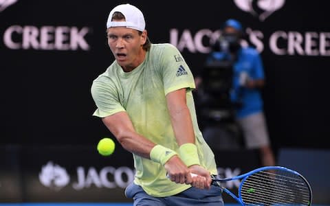 Czech Republic's Tomas Berdych hits a return against Switzerland's Roger Federer during their men's singles quarter-finals match on day 10 of the Australian Open tennis tournament in Melbourne on January 24, 2018 - Credit: AFP