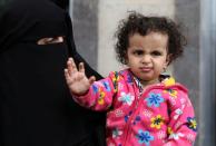 Girl gestures before boarding a United Nations plane which will carry her and other patients to Amman, Jordan in the first flight of a medical air bridge from Sanaa airport in Sanaa, Yemen