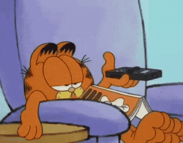 Garfield flicks through channels while sitting on a large chair