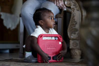 Kole Jones, great grandson of Lydia Gerard, a member of Concerned Citizens of St. John the Baptist Parish, holds a toy as she and residents speak to The Associated Press in Reserve, La., near the Denka Performance Elastomer Plant on Thursday, Sept. 15, 2022. The investigation of the plant is part of a push by the Biden administration to prioritize environmental enforcement in communities overburdened by pollution. (AP Photo/Gerald Herbert)