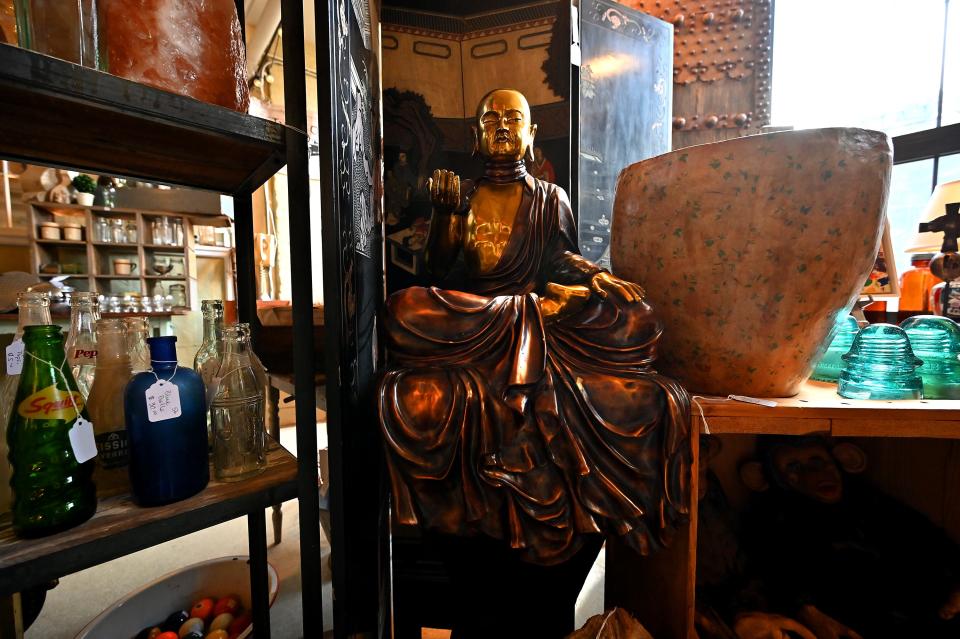 A large gold Buddha ($1,200) presides over its shelf at the Crompton Collective.