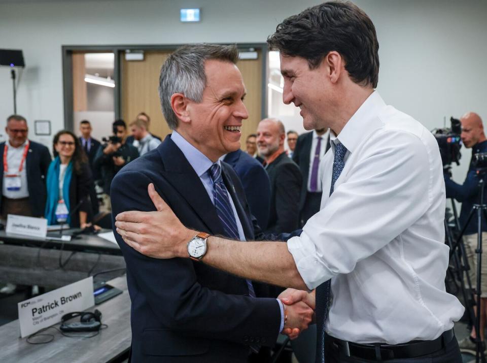 Prime Minister Justin Trudeau, left, greets Ottawa mayor Mark Sutcliffe as he attends a meeting of the Federation of Canadian Municipalities in Calgary, on Friday, June 7, 2024.