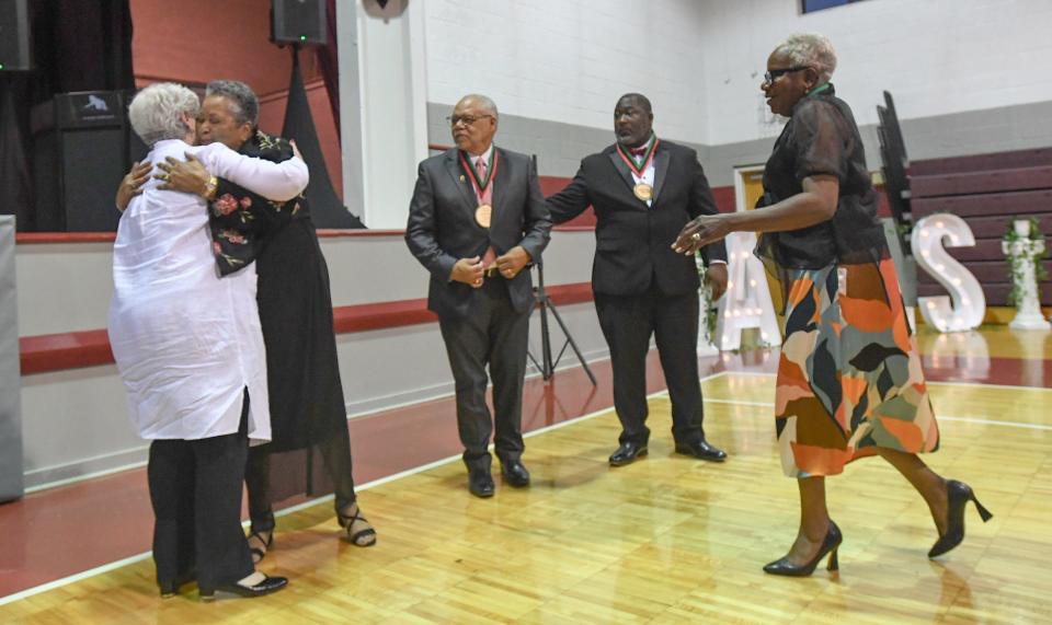 Carol Burdette, President & Chief Executive Officer of United Way of Anderson County hugs Sandra Gantt near Dr. Jerome Hudson, Don Peppers and Juana Slade, during the 2024 African American Leadership Society awards at the Westside Community Center in Anderson, S.C. Friday, June 21, 2024.