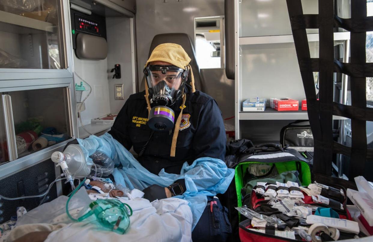 <span class="caption">With a large number of patients with COVID-19, doctors face difficult choices.</span> <span class="attribution"><a class="link " href="https://www.gettyimages.com/detail/news-photo/empress-ems-captain-aj-briones-wearing-a-personal-news-photo/1217635744?adppopup=true" rel="nofollow noopener" target="_blank" data-ylk="slk:John Moore/Getty Images;elm:context_link;itc:0;sec:content-canvas">John Moore/Getty Images</a></span>