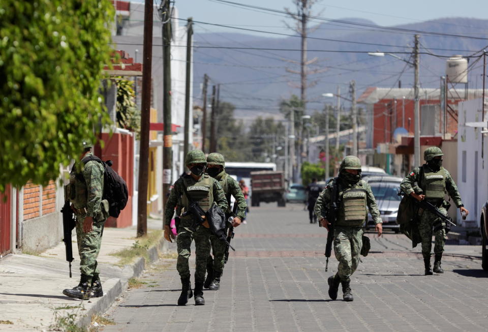 Members of the Mexican army walk near the house where nine people were killed by unknown assailants, according to local media, in Atlixco, Mexico March 9, 2022. / Credit: IMELDA MEDINA/REUTERS