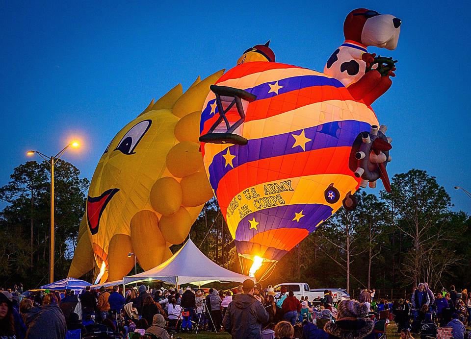 Spectators watch as two hot air balloons are filled at sunset at the St. Augustine Hot Air Balloon Festival at the St. Johns County Fairgrounds on March 13, 2022. The Aiken Hot Air Balloon Festival is set for April 30-May 1 at the Western Carolina State Fairgrounds.