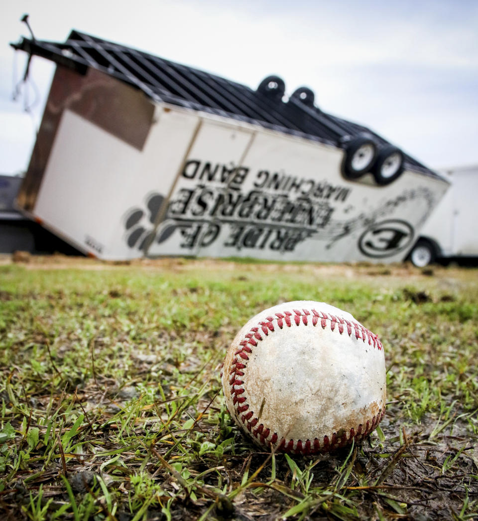 Thursday morning's daylight shows the damage done to the area in Enterprise, Miss. The Enterprise High School band's travel trailer was overturned and rested between the band hall and baseball field after a severe storm raced through the town Wednesday night, Feb. 5, 2020. (Paula Merritt/The Meridian Star via AP)