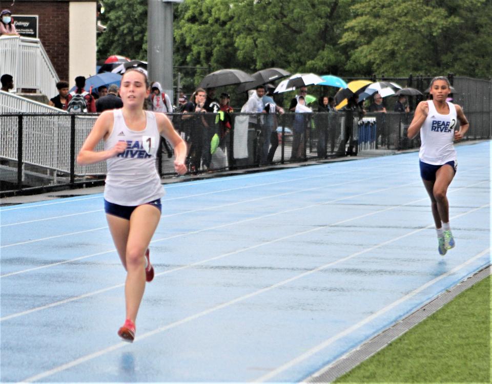 A drenched Una Boylan heads for the finish of the girls Section 1 Class B 3,000-meter run, followed by Pearl River teammate Madyson Moroney May 28, 2022 at Hen Hud. Boylan won and Moroney was second.