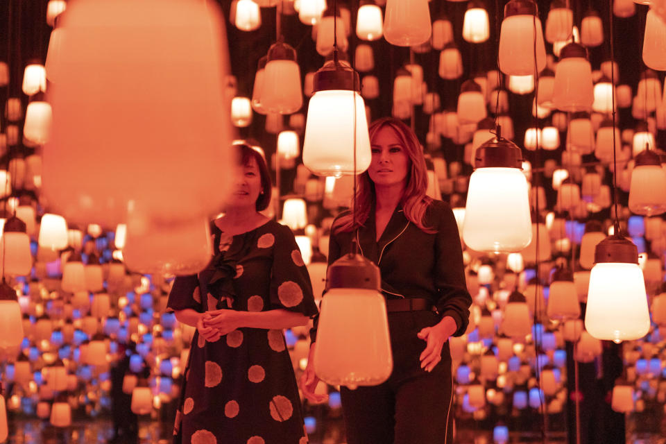 U.S. first lady Melania Trump, right, and Japanese Prime Minister Shinzo Abe's wife Akie Abe visit a digital art museum in Tokyo Sunday, May 26, 2019. (Pierre-Emmanuel Deletree/Pool Photo via AP)