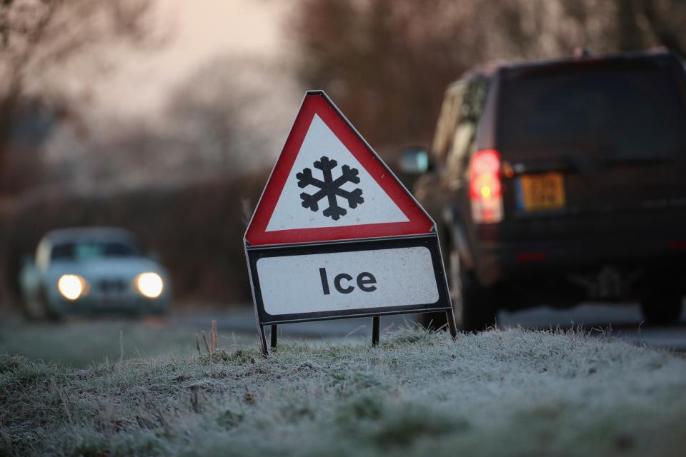 KNUTSFORD, ENGLAND - DECEMBER 11: A warning triangle alerts drivers to an icy road on December 11, 2012 in Knutsford, England. Forecasters are warning that the UK could experience the coldest day of the year so far tomorrow, as temperatures could drop as low as -14C, bringing widespread ice, harsh frosts and freezing fog. Travel disruption is expected with warnings for heavy snow. (Photo by Christopher Furlong/Getty Images)