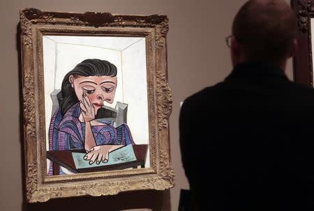 A visitor stops to look at a painting by Picasso at the Detroit Institute of Arts in Detroit, Michigan June 2, 2013. REUTERS/Rebecca Cook