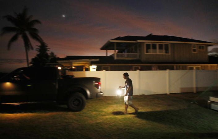 <p>Jay Kitashima loads up his truck after securing his tiny home in preparation for Hurricane Lane, Wednesday, Aug. 22, 2018, along Ewa Beach in Honolulu. (Photo: John Locher/AP) </p>
