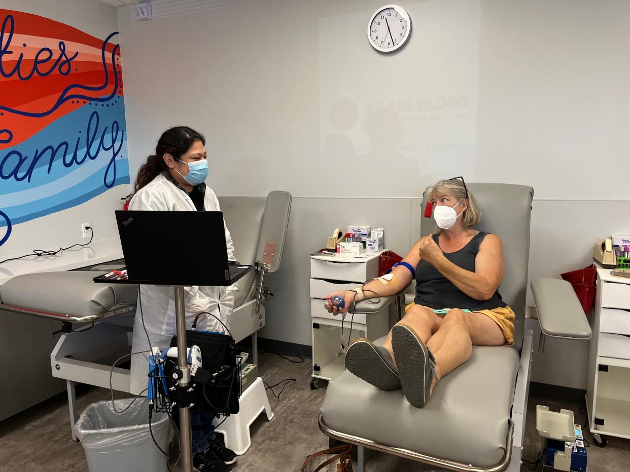 Melanie O'Neill talks to phlebotomist April Cordoba as she gives blood at the new Cedar Park location for We Are Blood. "I try to be pretty religious about it," said O'Neill, who says she has been donating blood since she was 17.