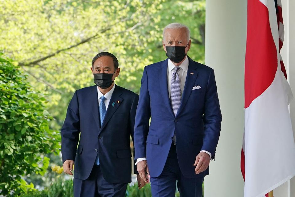 US President Joe Biden and Japan's Prime Minister Yoshihide Suga walk through the Colonnade to take part in a joint press conference in the Rose Garden of the White House in Washington, DC on April 16, 2021. (Photo by MANDEL NGAN / AFP) (Photo by MANDEL NGAN/AFP via Getty Images)