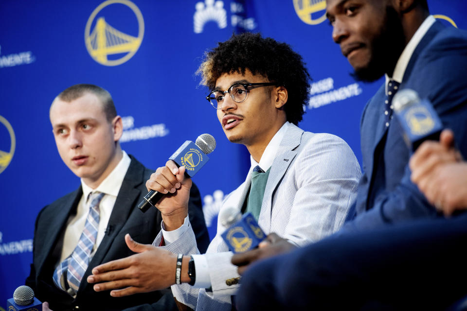 Golden State Warriors NBA basketball draft pick Jordan Poole, center, speaks with reporters on Monday, June 24, 2019, in Oakland, Calif. Fellow incoming Warriors Alen Smailagic, left, and Eric Paschall, right, flank Poole. (AP Photo/Noah Berger)