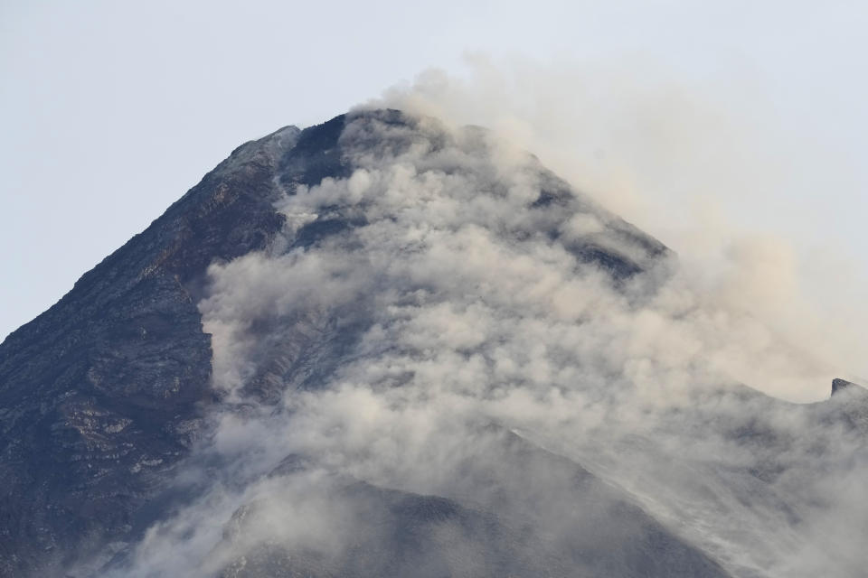 Steam from Mayon volcano is seen from Daraga town, Albay province, northeastern Philippines, Tuesday, June 13, 2023. Truckloads of villagers on Tuesday fled from Philippine communities close to gently erupting Mayon volcano, traumatized by the sight of red-hot lava flowing down its crater and sporadic blasts of ash. (AP Photo/Aaron Favila)