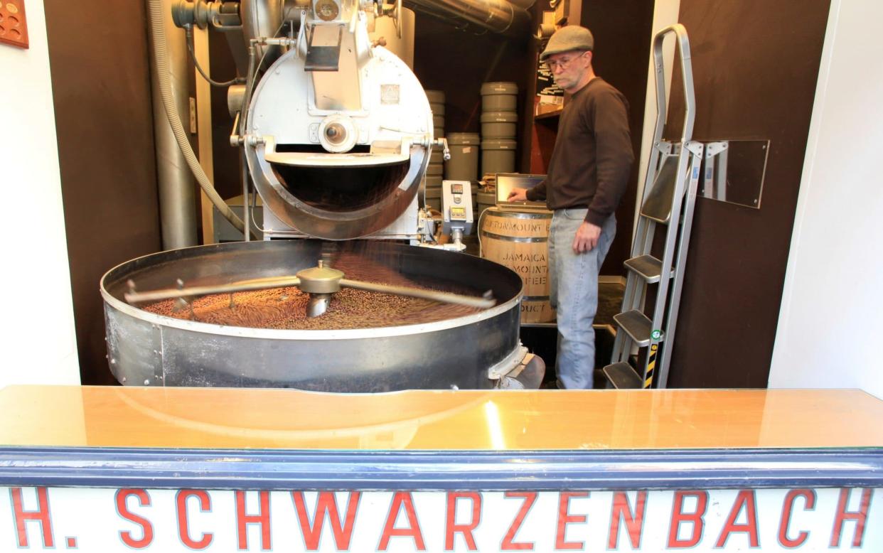 Freshly roasted coffee beans fall into roaster at H. Schwarzenbach coffee roastery in Zurich, Switzerland  - REUTERS