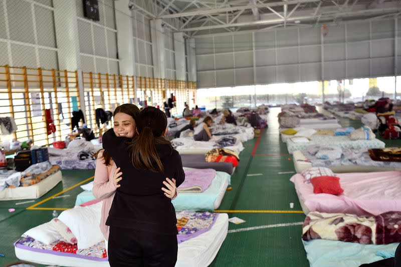 People fleeing amid Russia's ongoing invasion of Ukraine arrive at Dumbraveni sports arena in Suceava