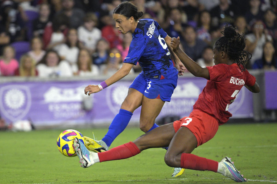U.S. forward Mallory Swanson (9) attempts a shot on goal as Canada's Kadeisha Buchanan (3) defends during the second half of a SheBelieves Cup soccer match Thursday, Feb. 16, 2023, in Orlando, Fla. (AP Photo/Phelan M. Ebenhack)