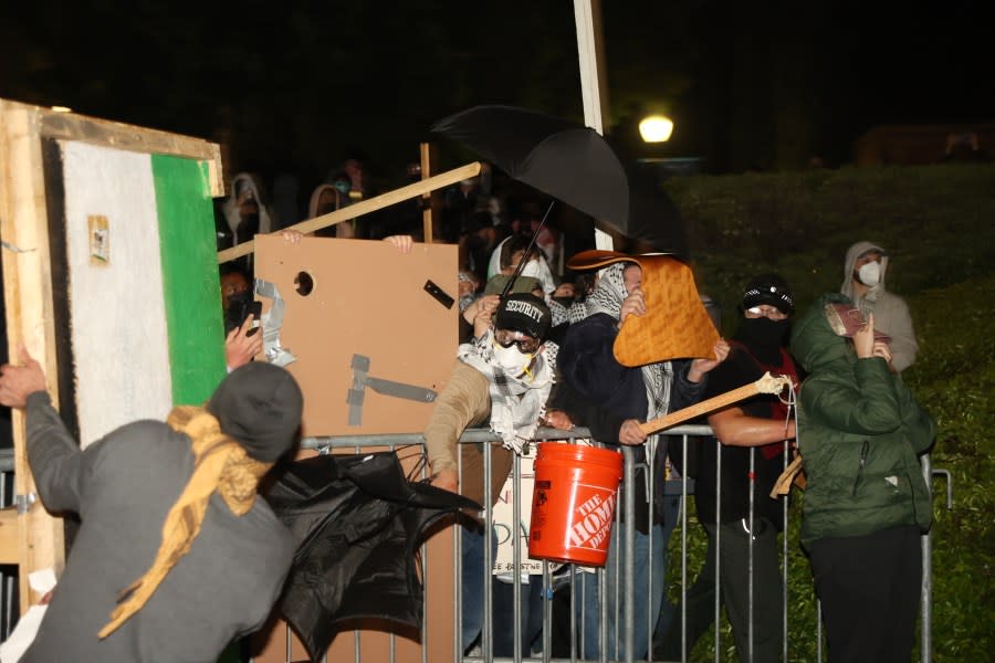 Los Angeles, CA – April 30: Barricades surround the encampment for the Pro- Palestine group as the pro-Israel group grabs the front barricades at UCLA on Tuesday, April 30, 2024 in Los Angeles, CA. (Michael Blackshire / Los Angeles Times via Getty Images)