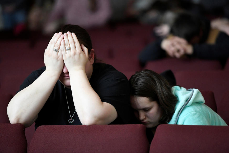 <p>Tiffany Moreland and her daughter Emily Moreland attend a prayer vigil for students killed and injured after a 15-year-old boy opened fire with a handgun at Marshall County High School, at Life in Christ Church in Marion, Kentucky, Jan. 23, 2018. (Photo: Harrison McClary/Reuters) </p>