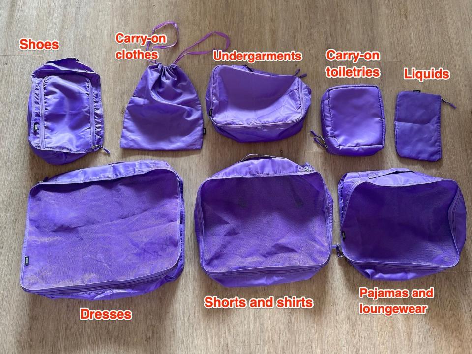 A set of packing cubes with labels for what they're used for.