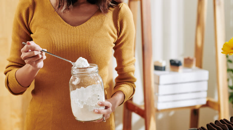 Person holding baking soda spoon