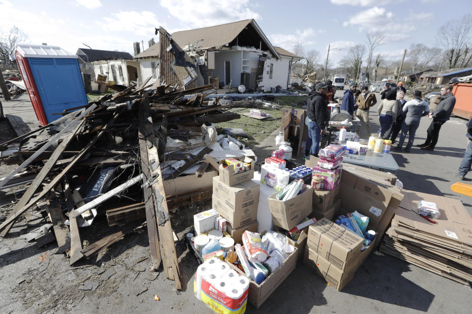 Household supplies are set up at a distribution center next to damaged homes Friday, March 6, 2020, in Nashville, Tenn. Residents and businesses face a huge cleanup effort after tornadoes hit the state Tuesday. (AP Photo/Mark Humphrey)