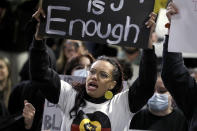 A woman holds a sign as protesters gather in Sydney, Tuesday, June 2, 2020, to support the cause of U.S. protests over the death of George Floyd and urged their own governments to address racism and police violence. Floyd died last week after he was pinned to the pavement by a white police officer who put his knee on the handcuffed black man's neck until he stopped breathing. (AP Photo/Rick Rycroft)