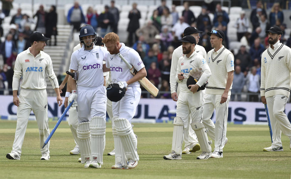 England's Joe Root, second left, carries a stump as he leaves the field with batting partner Jonny Bairstow after their win on the fifth day of the third cricket test match against New Zealand at Headingley in Leeds, England, Monday, June 27, 2022. (AP Photo/Rui Vieira)