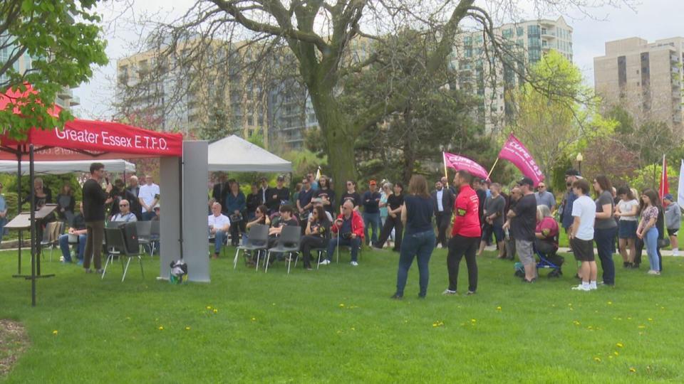 A crowd gathers at the memorial for fallen workers on Windsor's riverfront at Coventry Gardens on April 28, 2024.