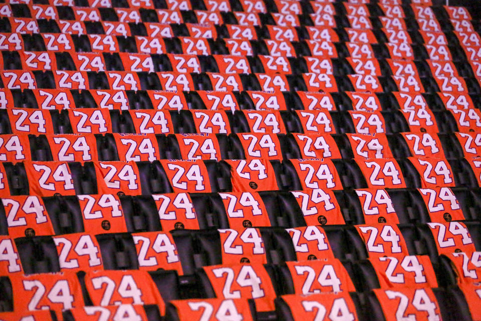 The Los Angeles Lakers honor the late Kobe Bryant by laying out t-shirts for fans prior to an NBA game against the Portland Trail Blazers at Staples Center Friday, Jan. 31, 2020, in Los Angeles. Bryant, the 18-time NBA All-Star who won five championships and became one of the greatest basketball players of his generation during a 20-year career with the Los Angeles Lakers, died in a helicopter crash Sunday. (AP Photo/Ringo H.W. Chiu)