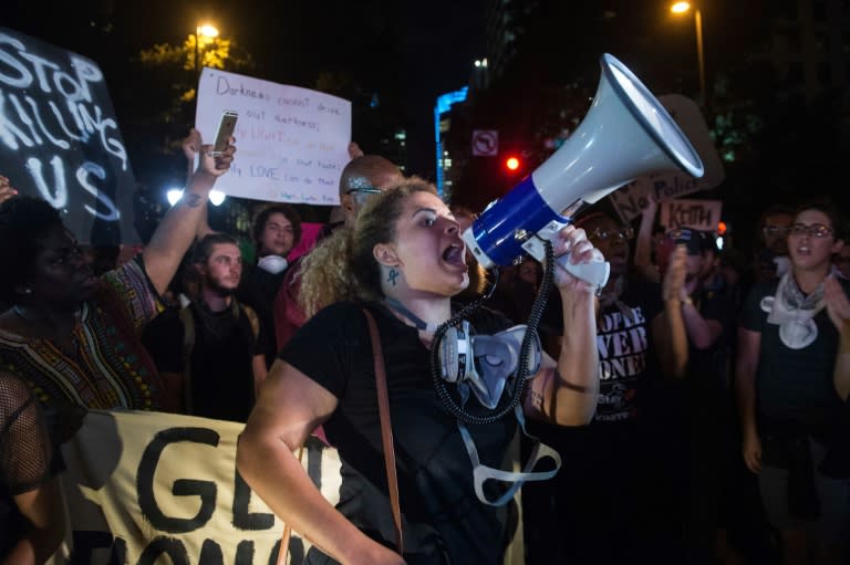 Hundreds marched to the city police station in Charlotte, North Carolina, carrying signs saying "Stop killing us" and "Resistance is beautiful"