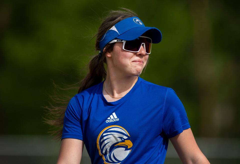 Evansville Christian’s Jacie Arnold looks back with a smile during practice Wednesday, April 19, 2023.