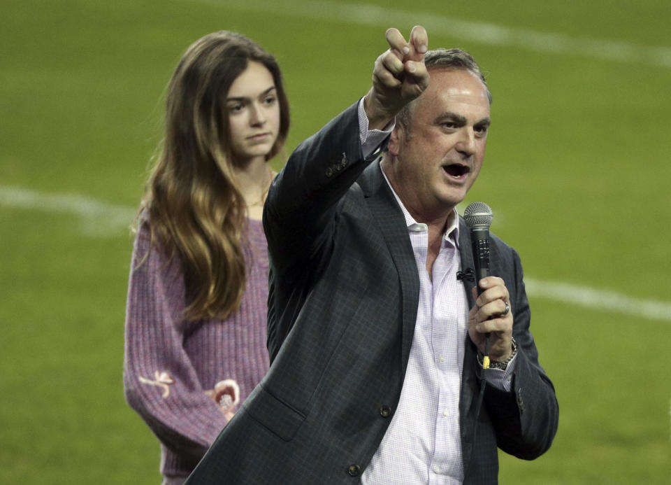 Sonny Dykes does the horned frog salute after being introduced and addressing the crowd as the new TCU head football coach at an event at Amon G. Carter Stadium at Texas Christian University, Monday, Nov. 29, 2021, in Fort Worth, Texas. (AP Photo/Richard W. Rodriguez)