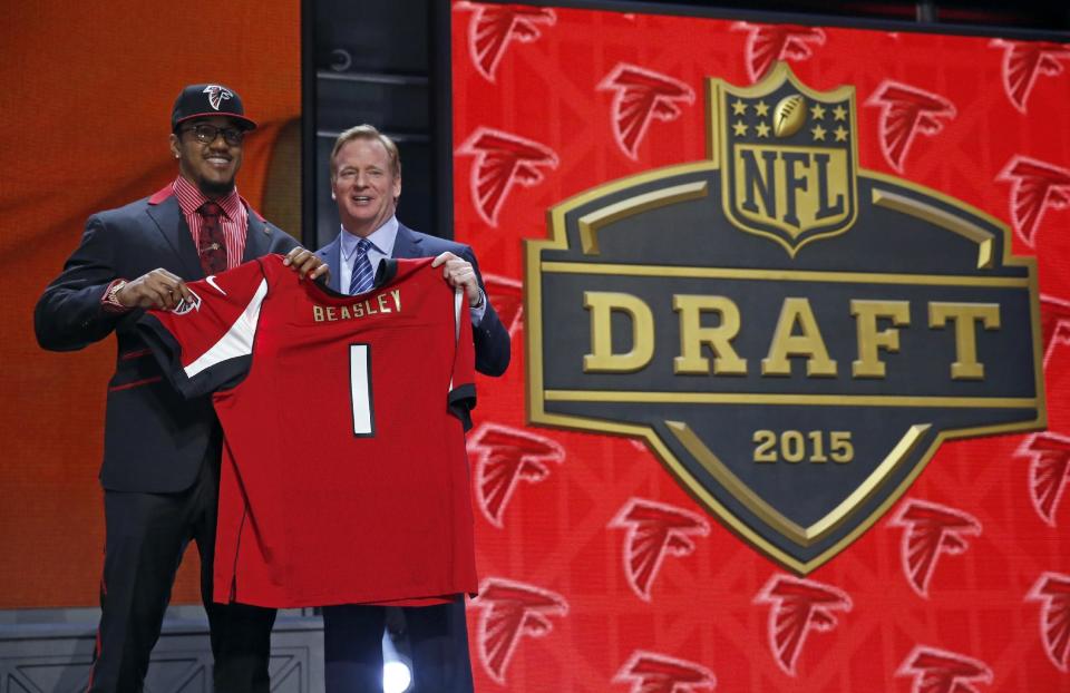 Clemson defensive lineman Vic Beasley poses for photos with NFL commissioner Roger Goodell after being selected by the Atlanta Falcons as the eighth pick in the first round of the 2015 NFL Draft, Thursday, April 30, 2015, in Chicago. (AP Photo/Charles Rex Arbogast)