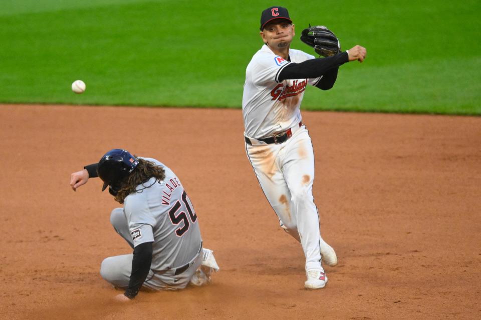 Cleveland Guardians second baseman Andres Gimenez (0) turns a double play against Detroit Tigers baserunner Ryan Vilade (50) in the seventh inning on Tuesday in Cleveland.