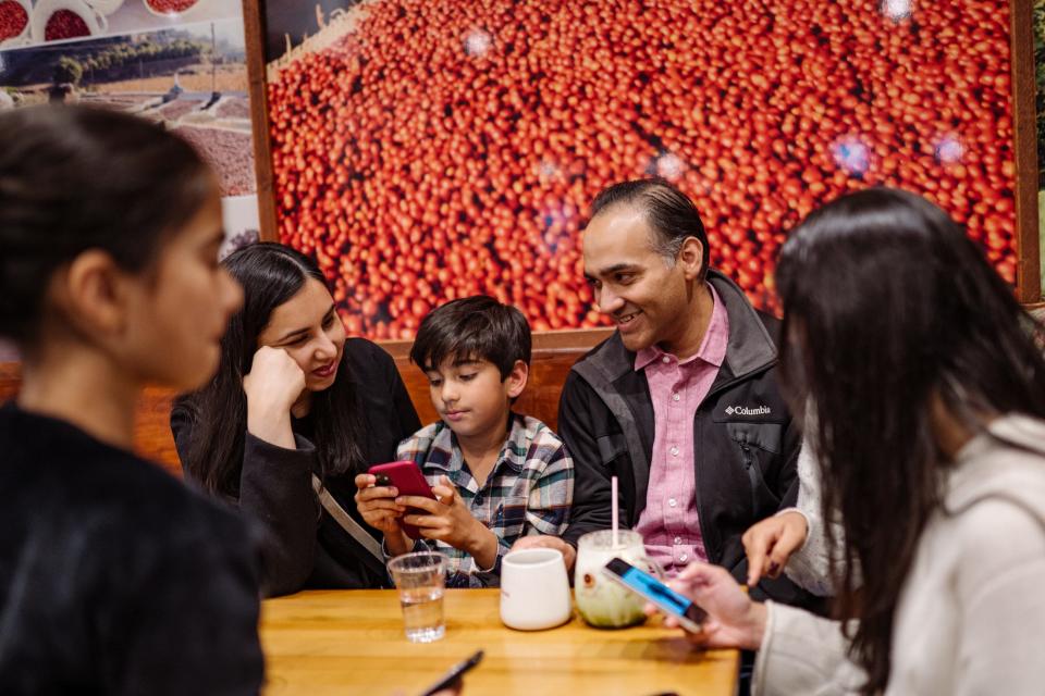 Customers drinking coffee at Yemeni coffee shop Qahwah House