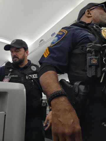 <p>TJ Monjay</p> Police officers on the plane