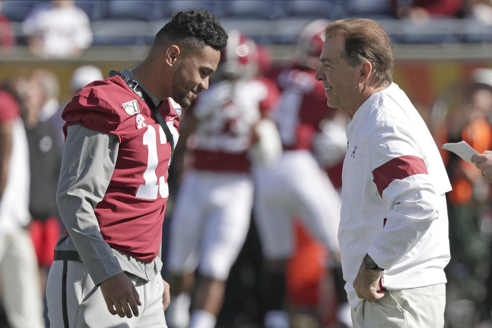 Alabama quarterback Tua Tagovailoa, left, talks with Alabama head coach Nick Saban before the Citrus Bowl NCAA college football game, Wednesday, Jan. 1, 2020, in Orlando, Fla. (AP Photo/John Raoux)