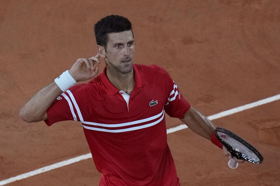 Serbia's Novak Djokovic celebrates winning the third set as he plays Spain's Rafael Nadal during their semifinal match of the French Open tennis tournament at the Roland Garros stadium Friday, June 11, 2021 in Paris. (AP Photo/Christophe Ena)