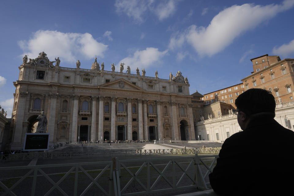 A man looks at St' Peter's Basilica at The Vatican, Saturday, Dec. 31, 2022. Pope Emeritus Benedict XVI, the German theologian who will be remembered as the first pope in 600 years to resign, has died, the Vatican announced Saturday. He was 95. (AP Photo/Andrew Medichini)
