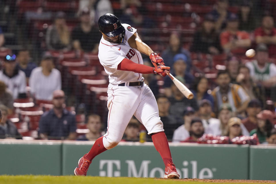 Boston Red Sox's Xander Bogaerts hits a two-run home run in the eighth inning of a baseball game against the Houston Astros, Monday, May 16, 2022, in Boston. The Red Sox won 6-3. (AP Photo/Steven Senne)