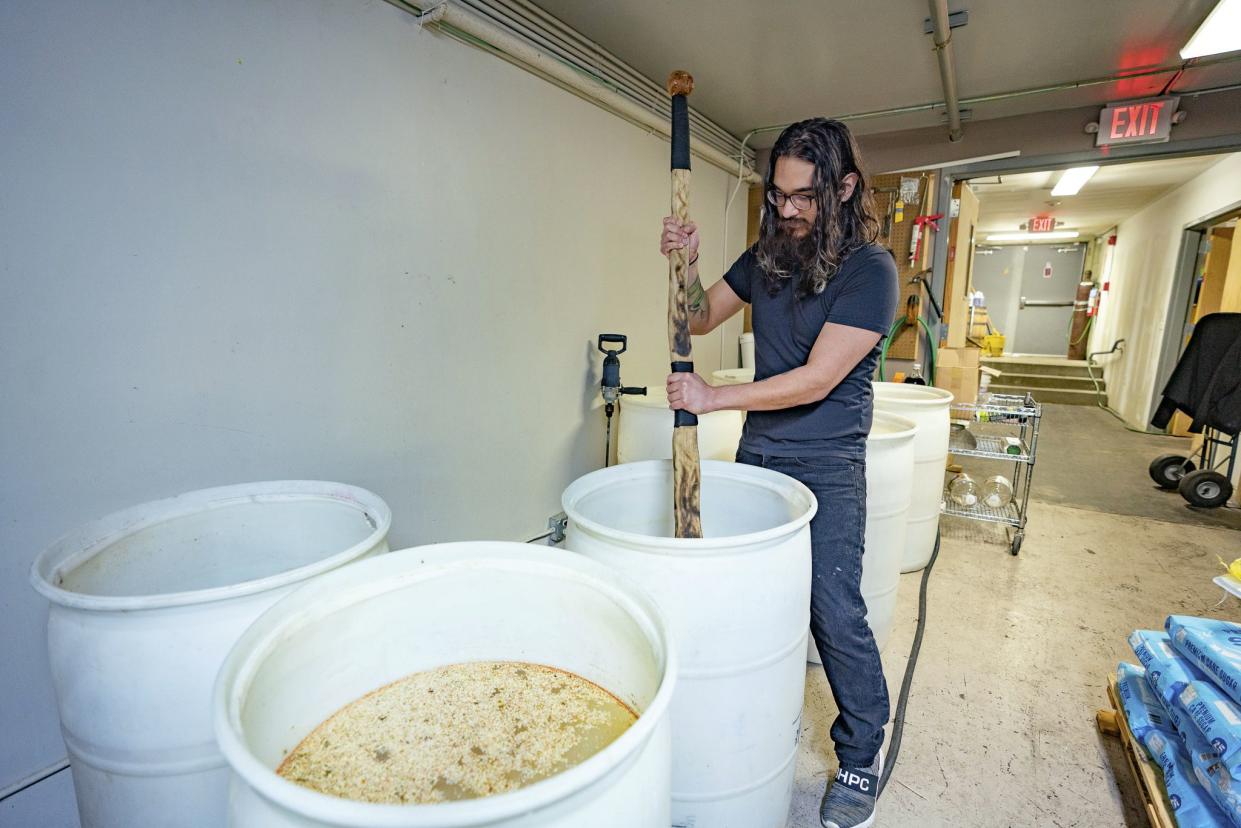 Octavio Ramos, Silent Brigade Distillery bar manager, checks on a batch of mash at the distillery in downtown Paducah, Ky. on Tuesday, March 24, 2020. Silent Brigade is making hand sanitizer and giving it to the public for free. Hand sanitizer has become a commodity in recent weeks due to the coronavirus pandemic.