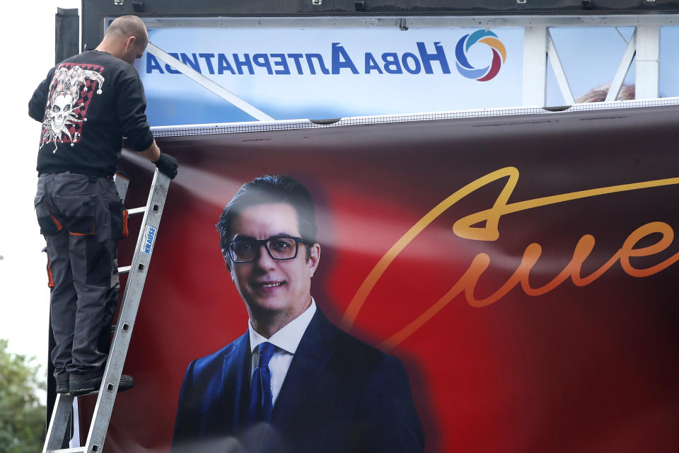 A worker removes an election poster of the incumbent President Stevo Pendarovski from a billboard, a day after the presidential and parliamentary elections, in Skopje, North Macedonia, on Thursday, May 9, 2024. North Macedonia elected its first woman president Wednesday as the governing Social Democrats suffered historic losses in twin presidential and parliamentary elections. (AP Photo/Boris Grdanoski)