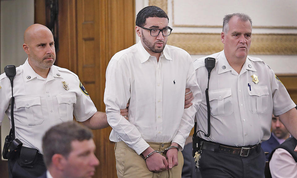 Emanuel "Manny " Lopes is escorted into court on day one of his trial for the 2018 murder of Weymouth Police Sgt. Michael Chesna and Vera Adams, in Norfolk Superior Court in Dedham, Mass., Thursday June 8, 2023. (Greg Derr/The Patriot Ledger via AP, Pool)